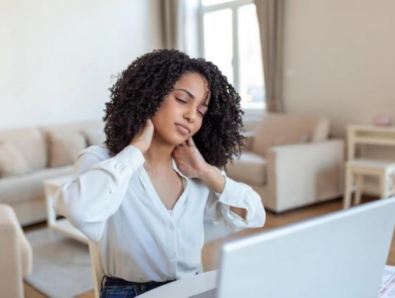 businesswoman feeling pain neck after sitting table with laptop tired female suffering office syndrome because long hours computer work pretty girl massaging her tense neck muscles 1212 5705